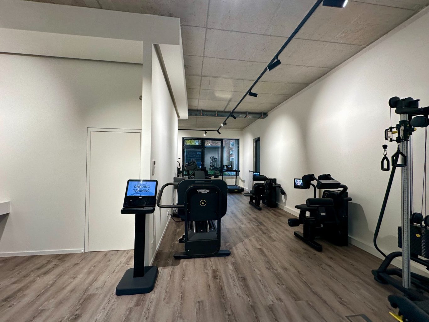 Moderne Trainingsgeräte in einem hellen, offenen Fitnessraum.